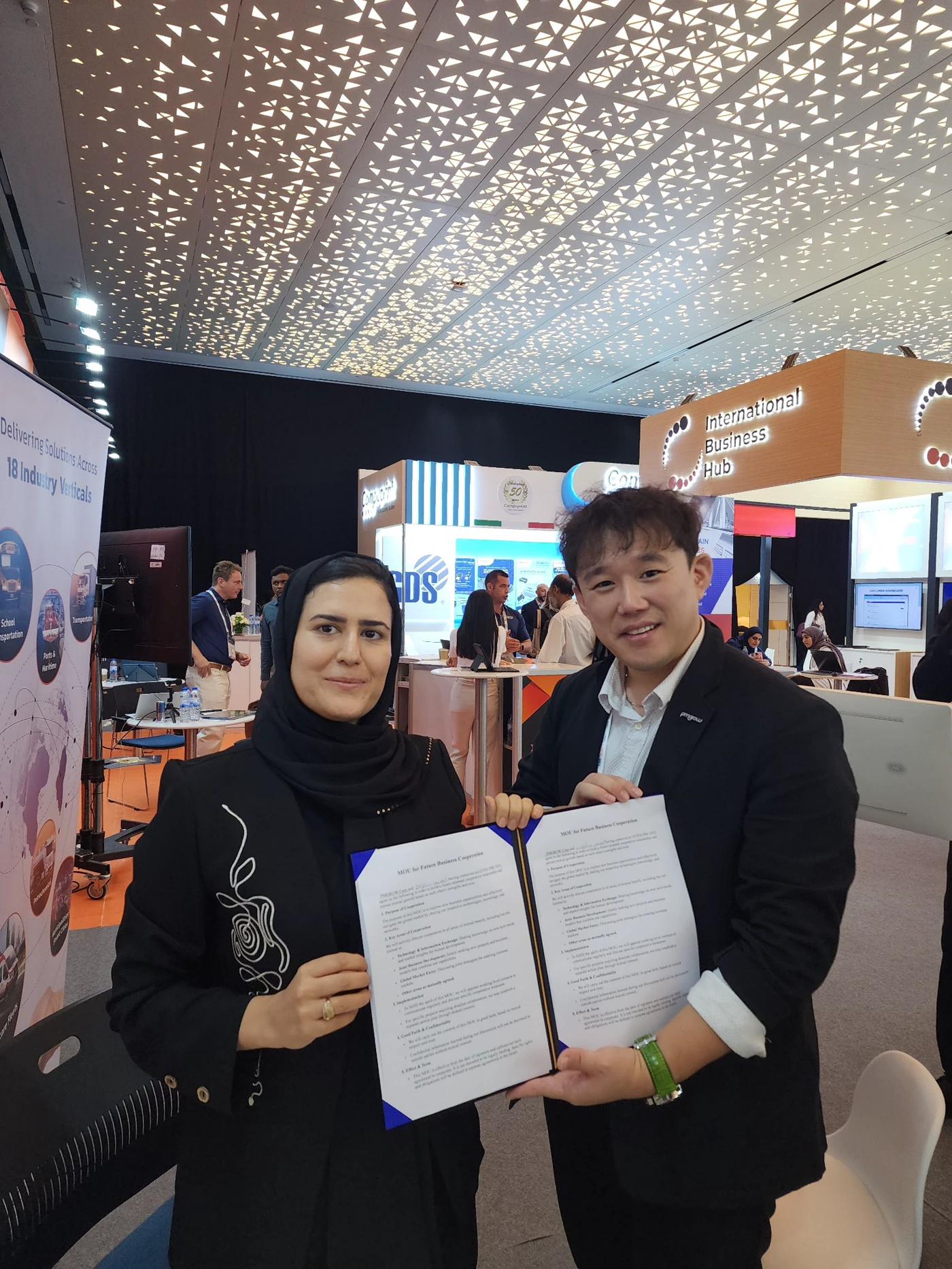Fatemeh Jamali and a business partner holding a signed agreement